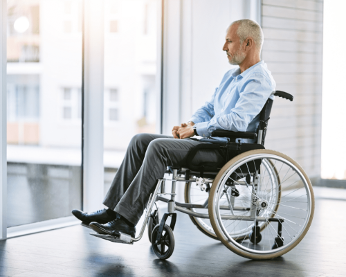 Man seated in a wheelchair near a large window, looking outward in a quiet indoor setting. The image conveys the long-term impact of catastrophic injuries, highlighting the importance of detailed medical documentation in proving the extent of harm, ongoing care needs, and damages in an Oklahoma City personal injury lawsuit.