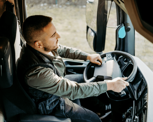 Truck driver seated behind the wheel of a commercial vehicle, illustrating driver operation and the safety responsibilities tied to negligent hiring and retention in Oklahoma City trucking accident cases.