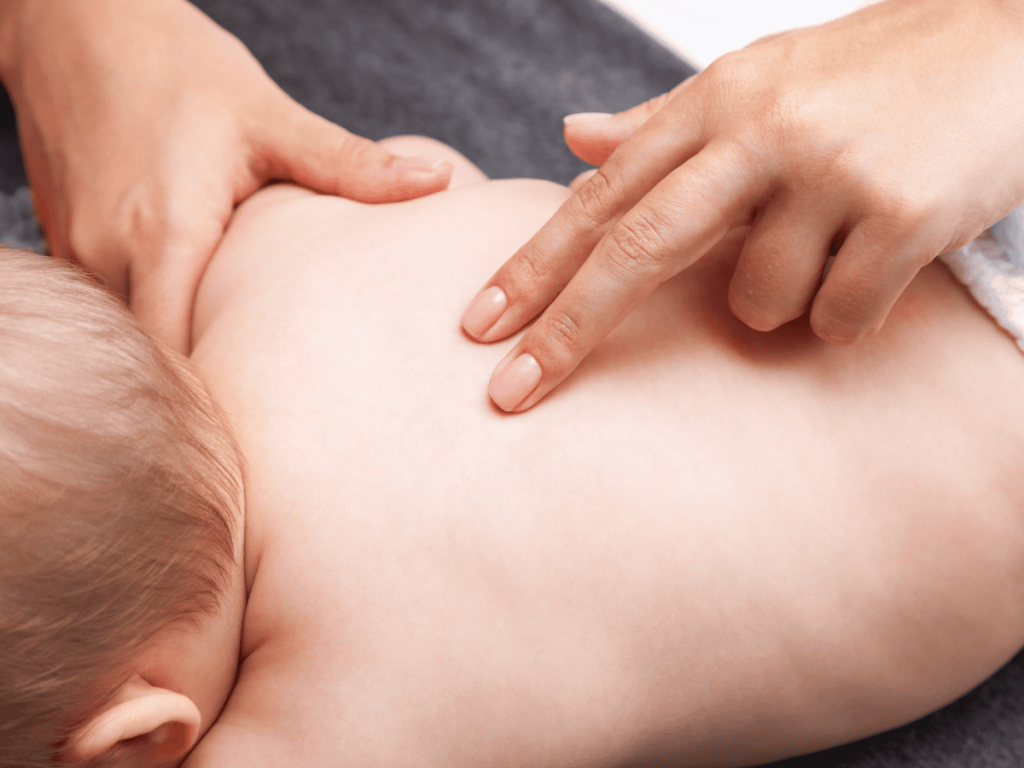 Healthcare provider examining a newborn's back during a medical assessment, illustrating spinal cord birth injuries, delivery-related trauma, and potential medical malpractice claims.
